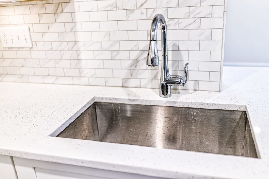 Granite counter around sink and tiled backsplash