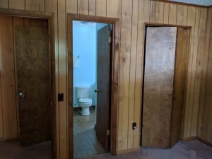 Wood paneling and doors to bathroom and closet