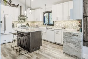 entrance to modern kitchen with granite countertops and tiled backsplash
