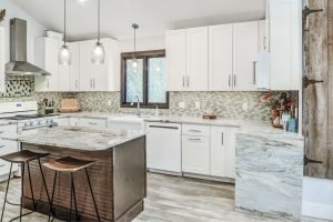 kitchen with granite breakfast island, countertop, and tile backsplash