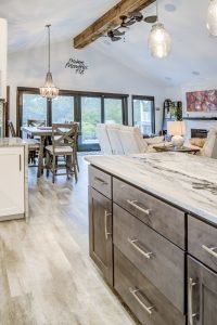 modern open floor plan home interior wiht hardwood flooring and granite countertops