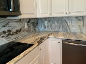 kitchen corner with granite countertop and backsplash